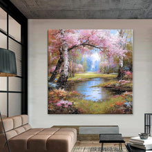 Вчитај ја сликата во галериски мод за гледање, Идилична шумска патека со бели стебла и розови цветови, опкружена со зелена трева и мирно сино езерце.